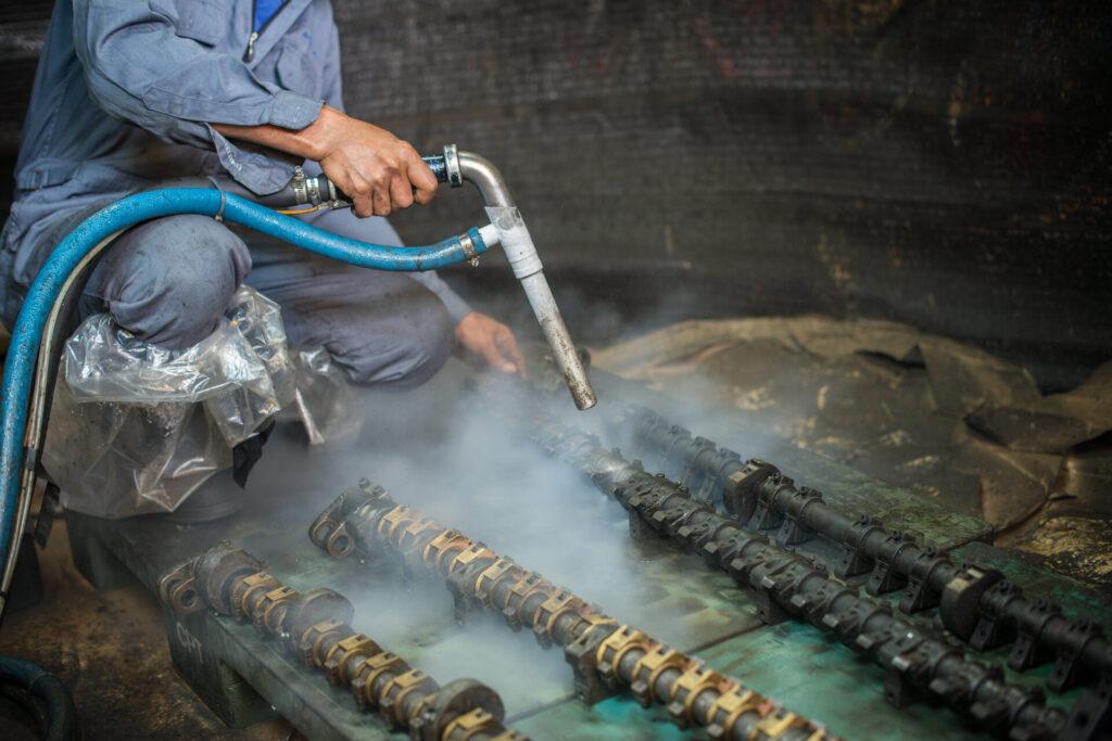 Worker is cleaning the machine equipment